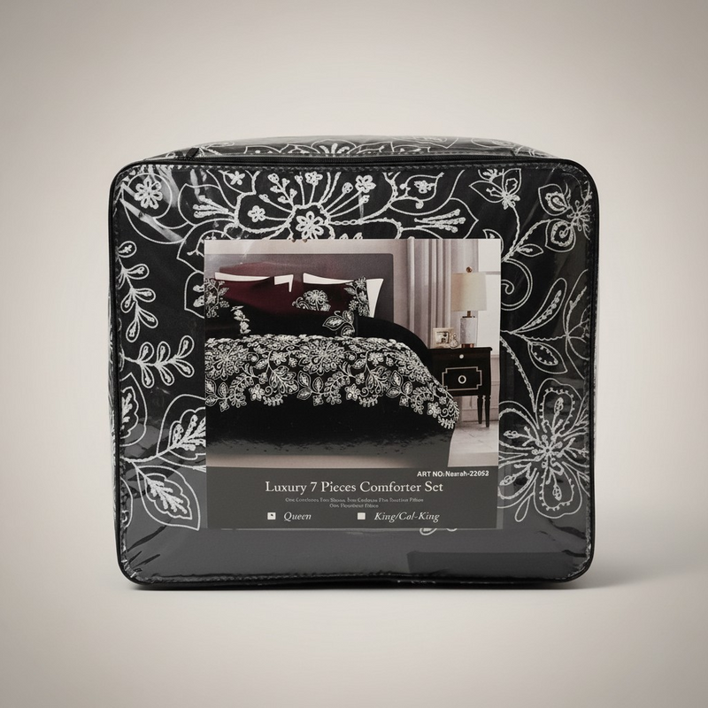 Packaged luxury 7-piece comforter set with decorative black and white floral design on packaging.